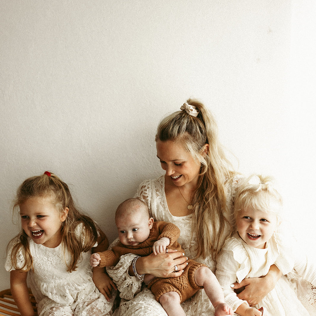 smiling mum with 3 children
