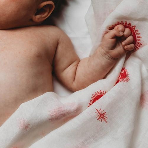 Newborn baby with organic muslin blanket